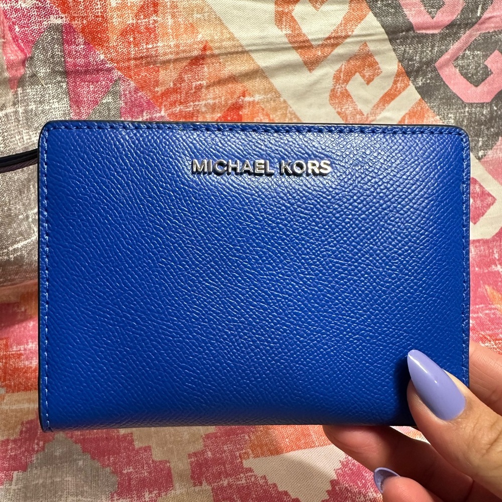 Used Michael Kors Blue wallet with multiple colors on the inside